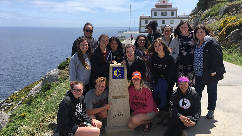 Students posing near monument on education abroad trip.