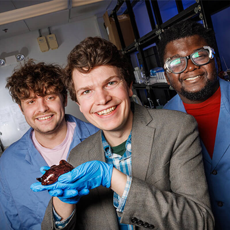 Faculty member and students holding slug