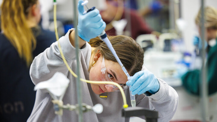 Elizabeth Stratman measures solution into a test tube during a biochemistry lab in February 2024.