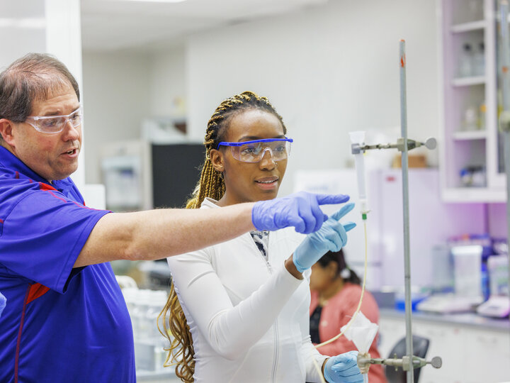 avour Wanjoku and biochemistry instructor Mark Behrens discuss the test setup to drip egg white solution to awaiting test tubes. Students isolate and purify lysozyme from actual egg whites in BIOC 401L - Laboratory for Elements of Biochemistry. February 13, 2024. Photo by Craig Chandler / University Communication and Marketing.